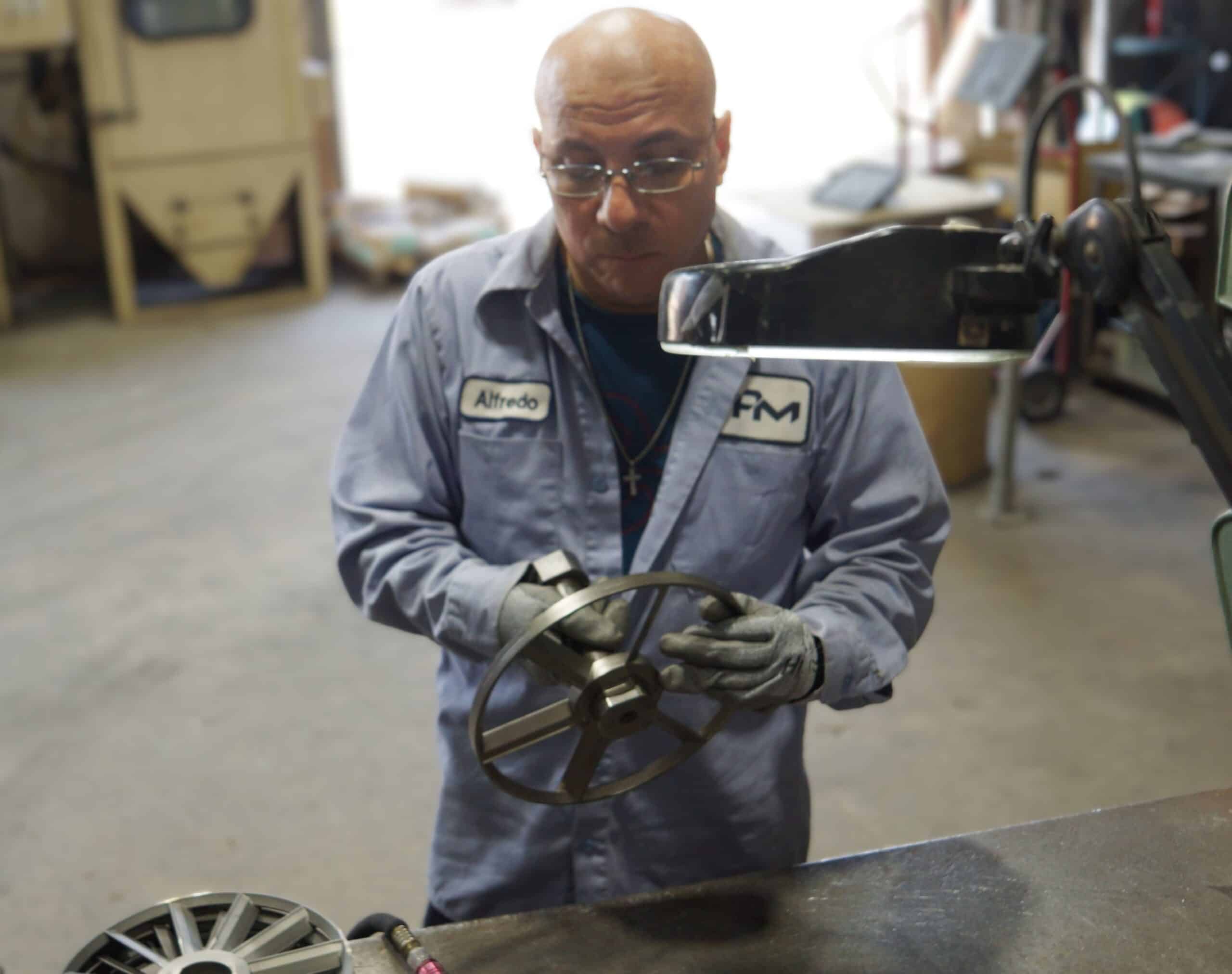 Employee handling a parts component