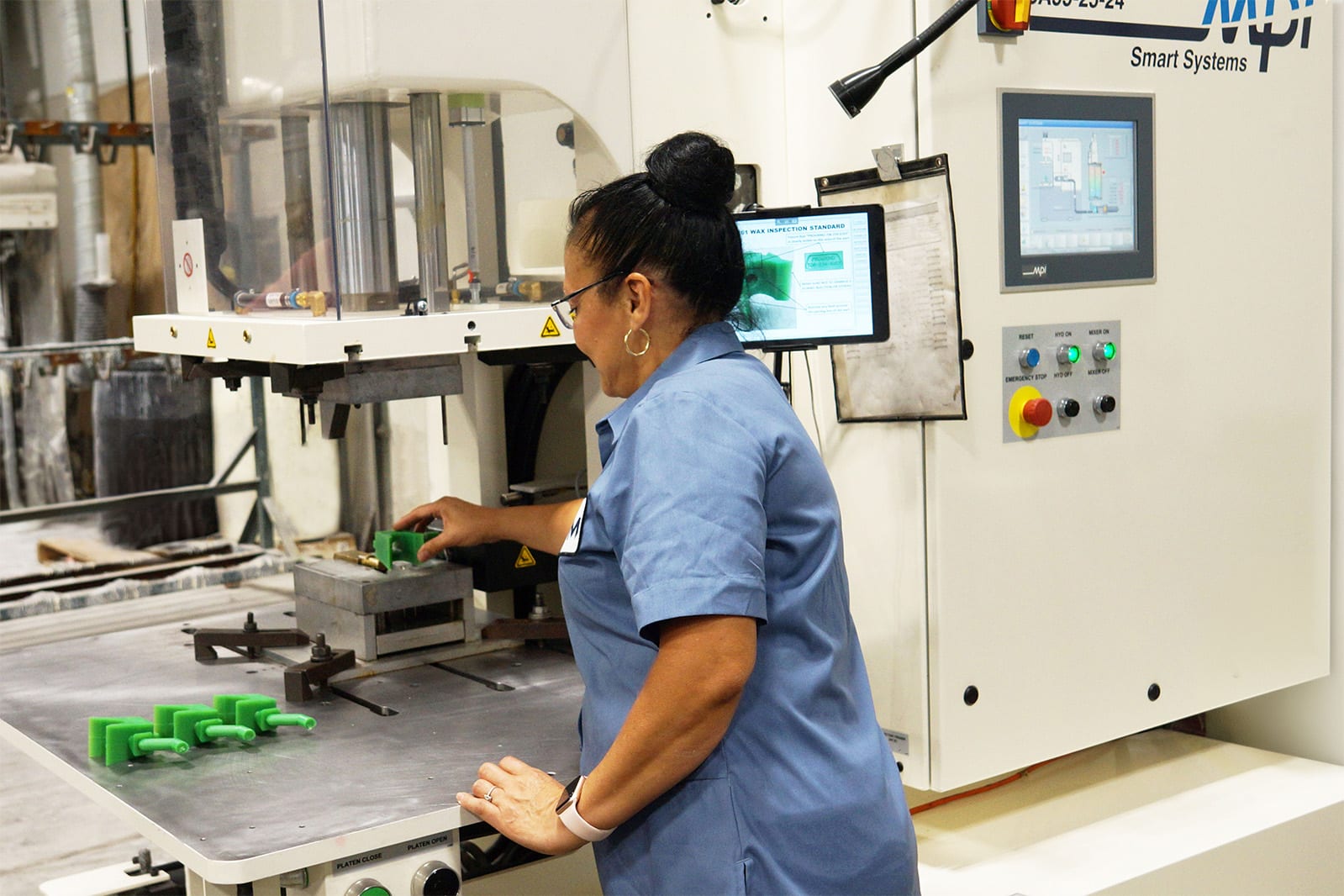 Employee creating green wax molds